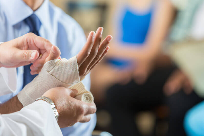 Doctor bandaging an injured hand